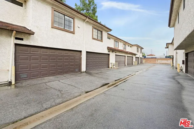 a street sign on a brick wall next to a road