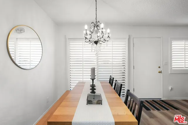 a view of a room with wooden floor windows and a chandelier