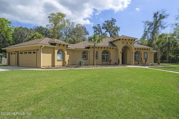 a front view of a house with a garden