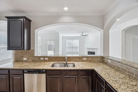 a bathroom with a granite countertop sink and a large mirror