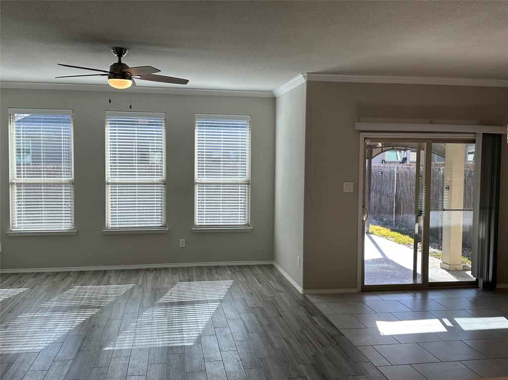 3716 Fossil Tree Lane Fort Worth, TX 76244 - Photo 11 of 30 an empty room with wooden floor and windows
