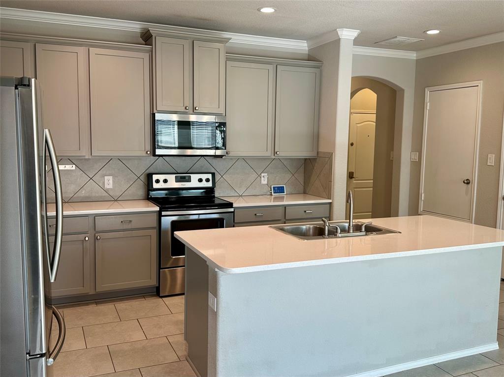3716 Fossil Tree Lane Fort Worth, TX 76244 - Photo 6 of 30 a kitchen with a sink and a refrigerator