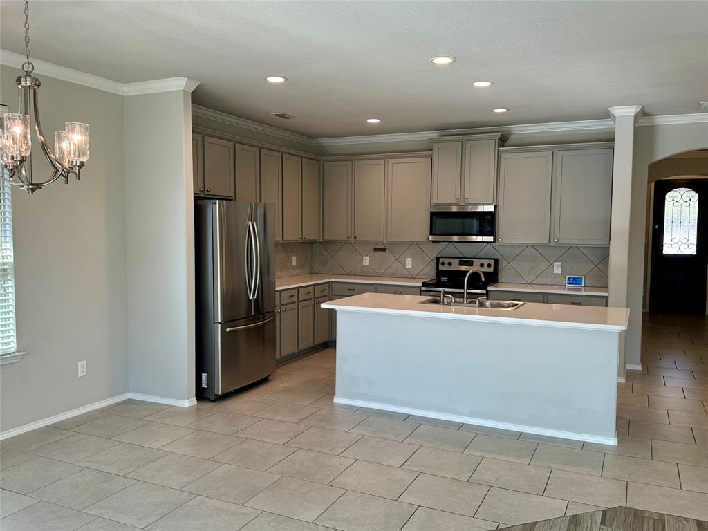 3716 Fossil Tree Lane Fort Worth, TX 76244 - Photo 8 of 30 a kitchen with stainless steel appliances granite countertop a refrigerator a stove a sink and a microwave