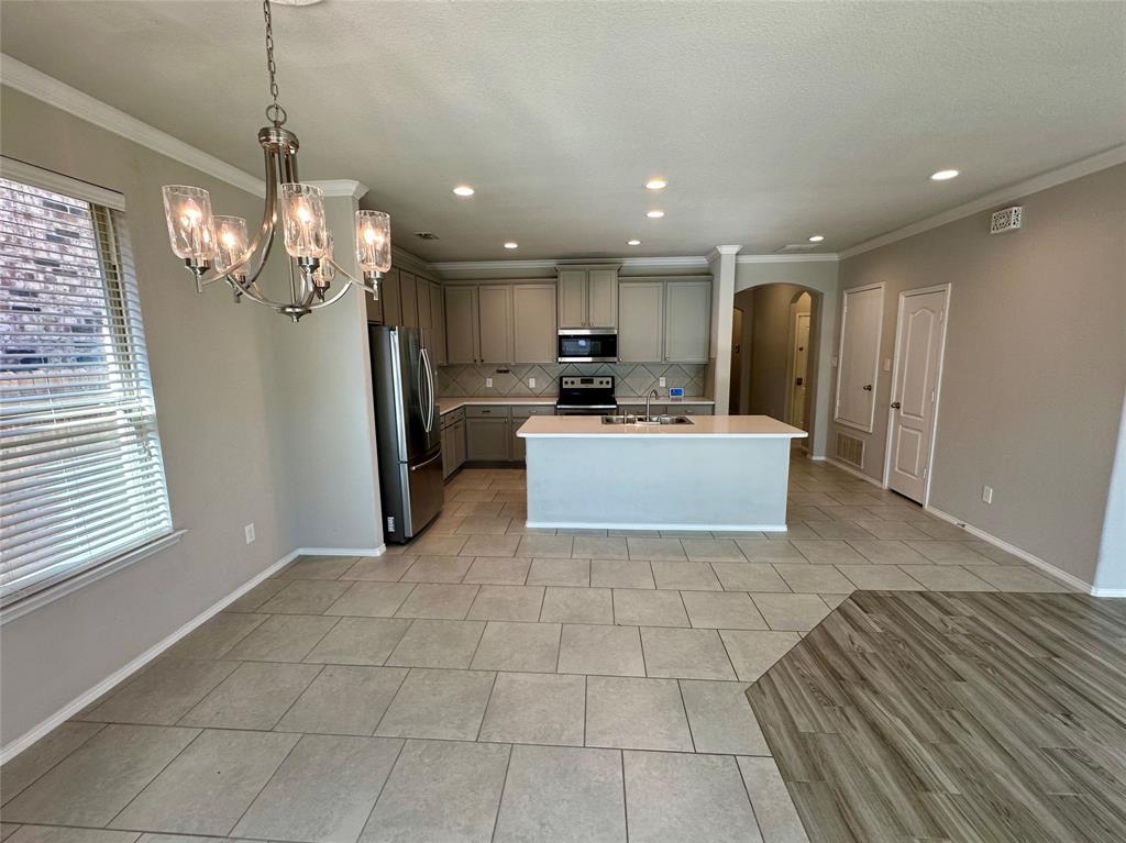 3716 Fossil Tree Lane Fort Worth, TX 76244 - Photo 9 of 30 a view of a kitchen with dining table and chairs