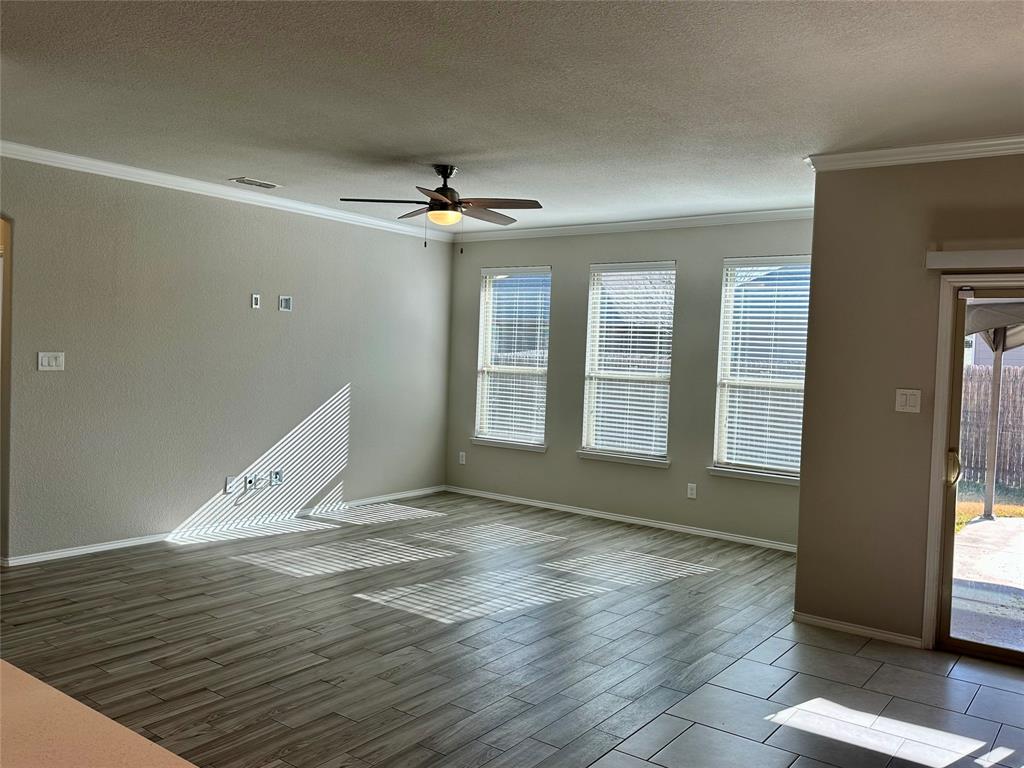 3716 Fossil Tree Lane Fort Worth, TX 76244 - Photo 10 of 30 a view of an empty room with window and wooden floor