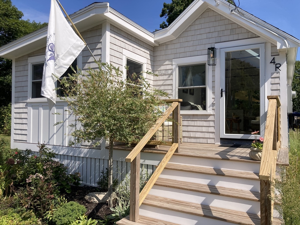 4 R Old County Road Rockport, MA 01966 - Photo 1 of 29 a front view of house with stairs and flowers