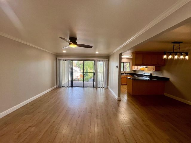 a view of kitchen with sink and wooden floor
