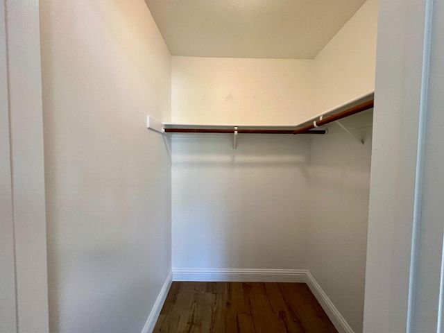 a view of walk in closet with clothes
