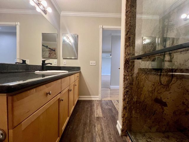 a spacious bathroom with a sink and mirror