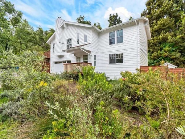 a house that has a tree in front of it