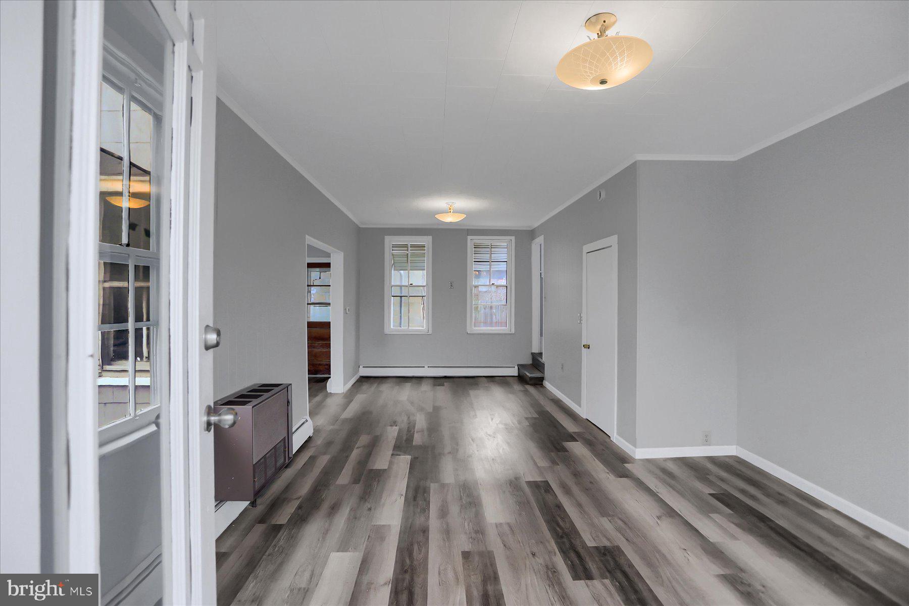114 South 5th Street Shamokin, PA 17872 - Photo 3 of 25 a view of an empty room with wooden floor and a window