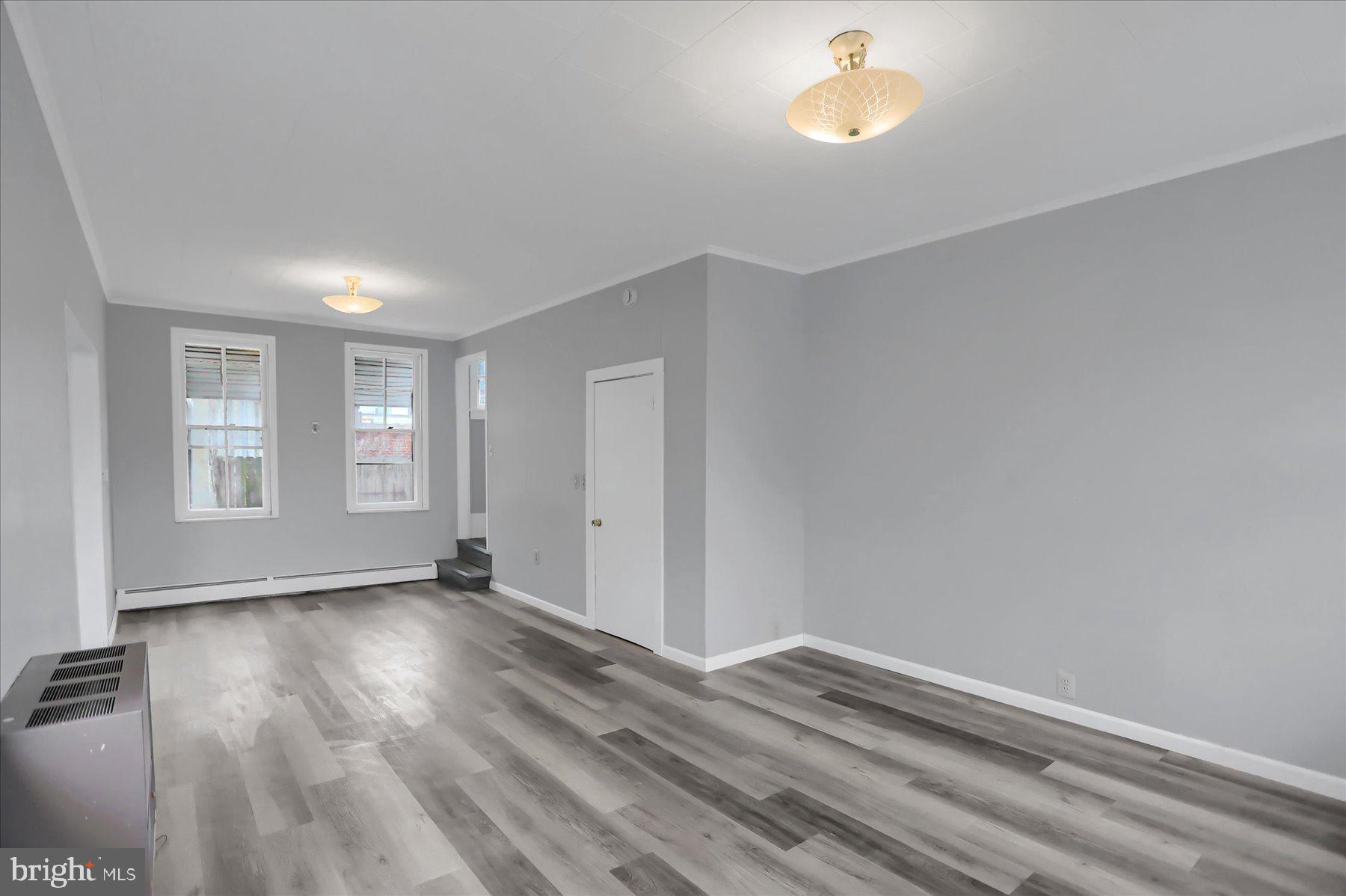 114 South 5th Street Shamokin, PA 17872 - Photo 4 of 25 a view of an empty room with window and wooden floor
