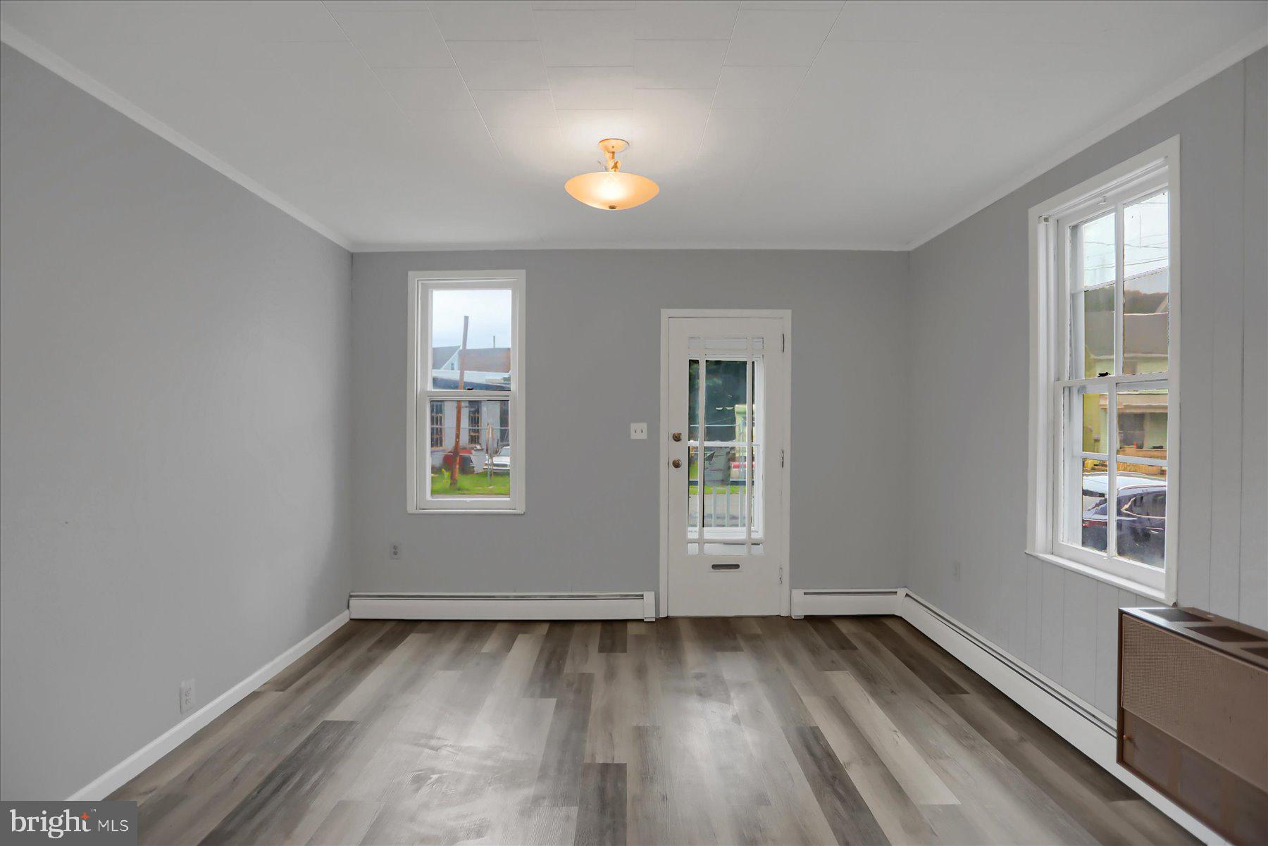 114 South 5th Street Shamokin, PA 17872 - Photo 5 of 25 an empty room with wooden floor and windows