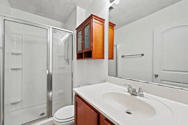 a bathroom with a sink toilet and shower