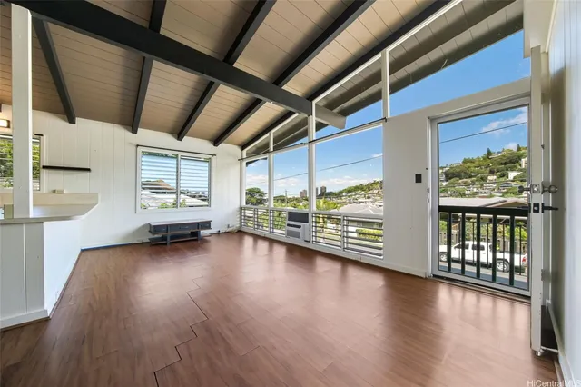 a view of a room with wooden floor and furniture