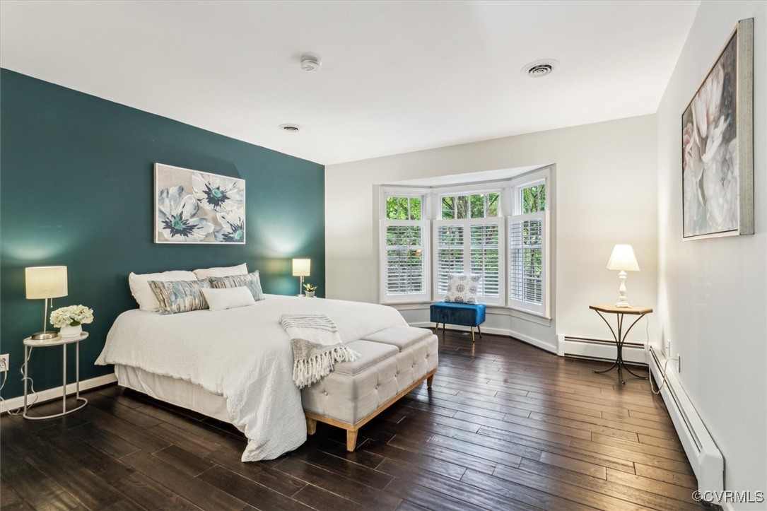 4704 Lady Slipper Path Williamsburg, VA 23188 - Photo 25 of 50 a large bedroom with a bed wooden floor and window
