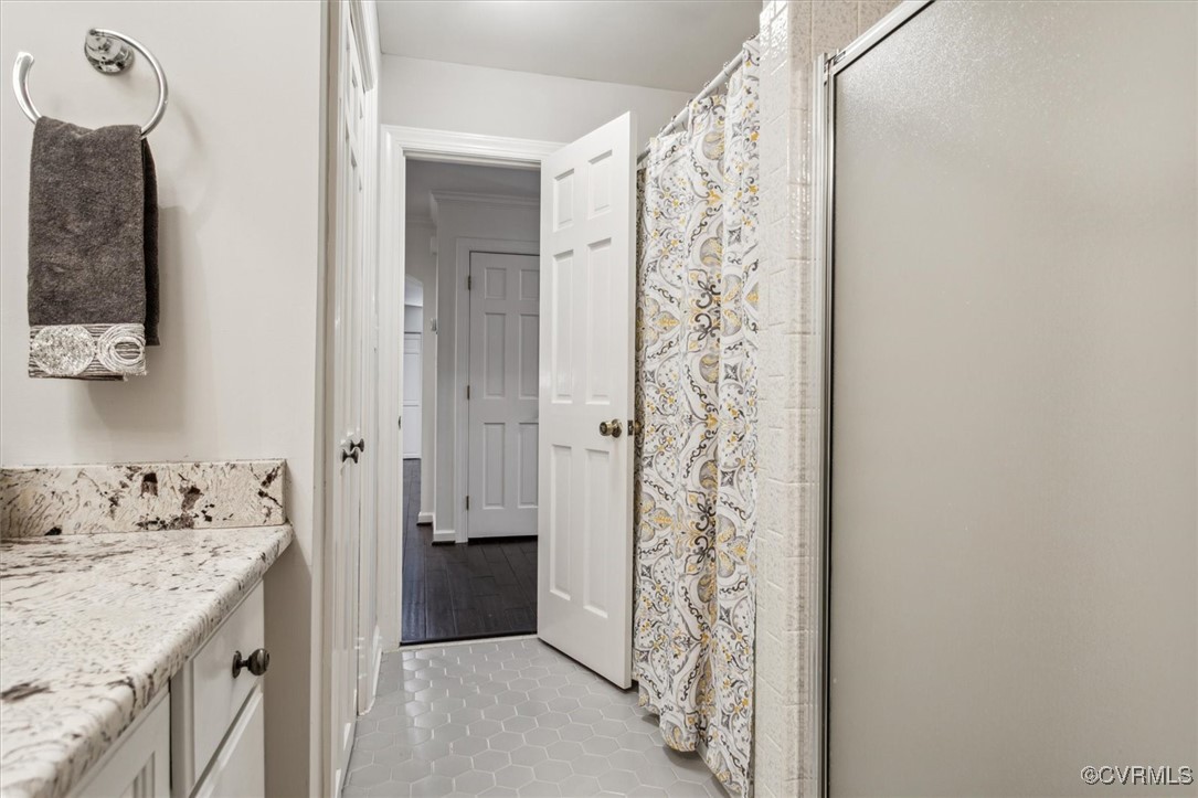 4704 Lady Slipper Path Williamsburg, VA 23188 - Photo 35 of 50 a bathroom with a granite countertop sink a shower and a mirror