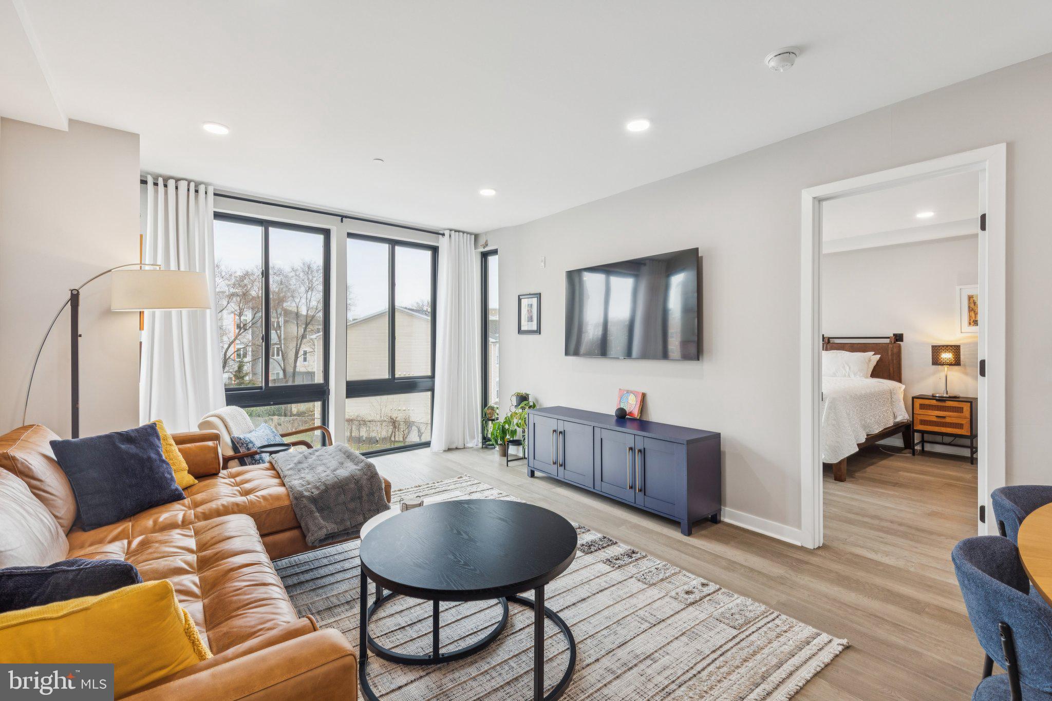 1648-50 Ridge Avenue, Unit 301 Philadelphia, PA 19130 - Photo 14 of 37 a living room with furniture and a flat screen tv