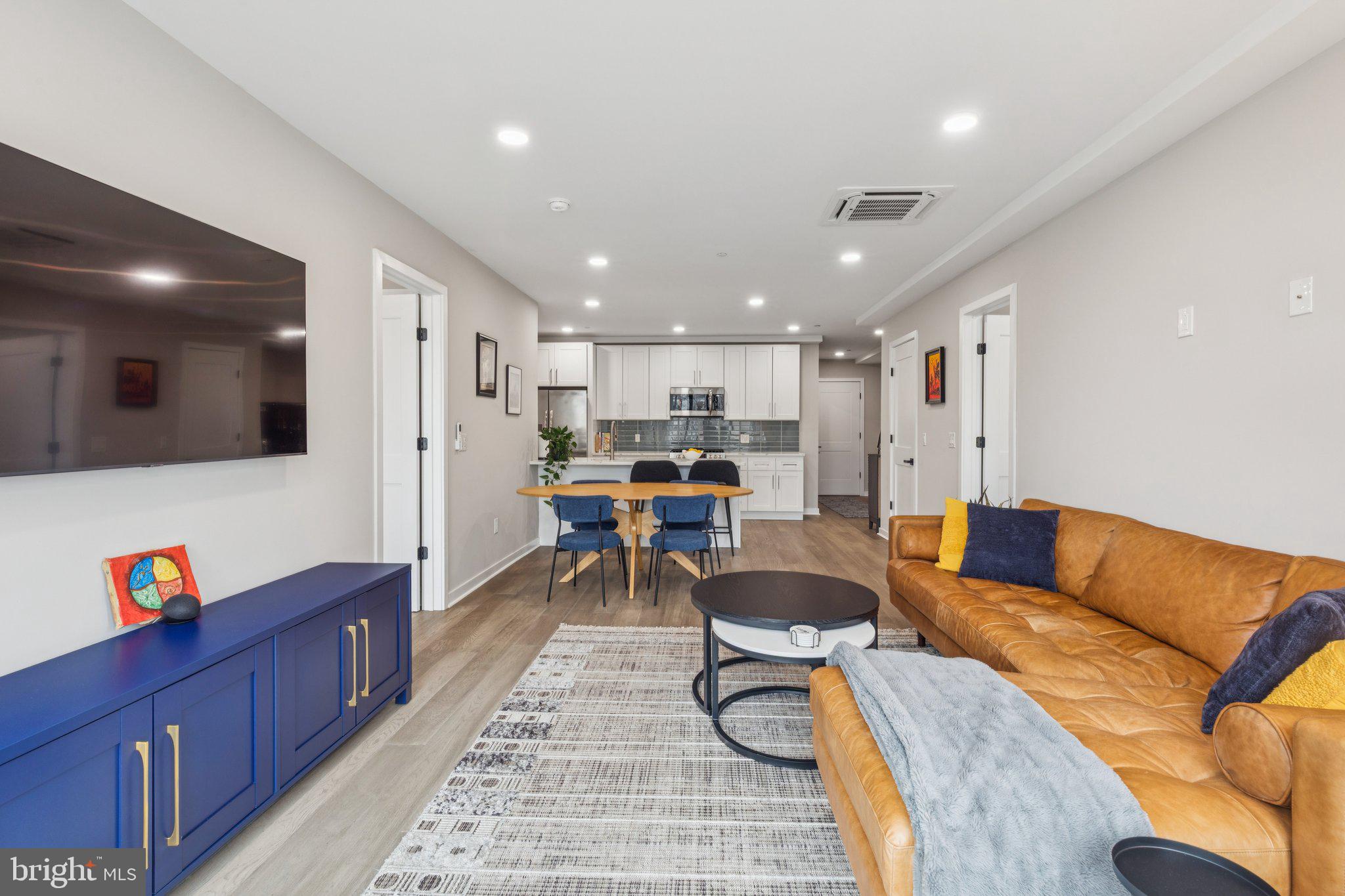 1648-50 Ridge Avenue, Unit 301 Philadelphia, PA 19130 - Photo 17 of 37 a living room with furniture and a flat screen tv