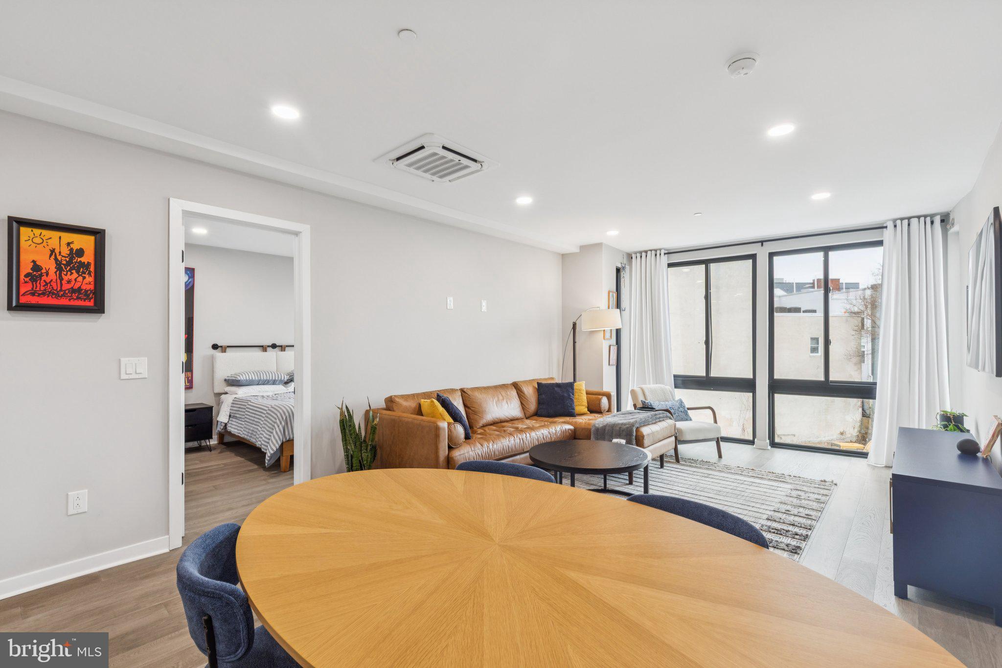 1648-50 Ridge Avenue, Unit 301 Philadelphia, PA 19130 - Photo 18 of 37 a living room with furniture and large windows