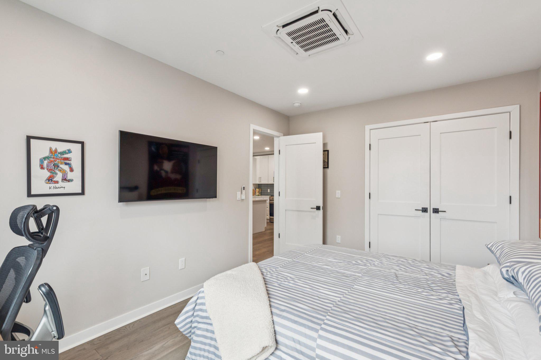 1648-50 Ridge Avenue, Unit 301 Philadelphia, PA 19130 - Photo 20 of 37 a bedroom with a bed and a flat screen tv