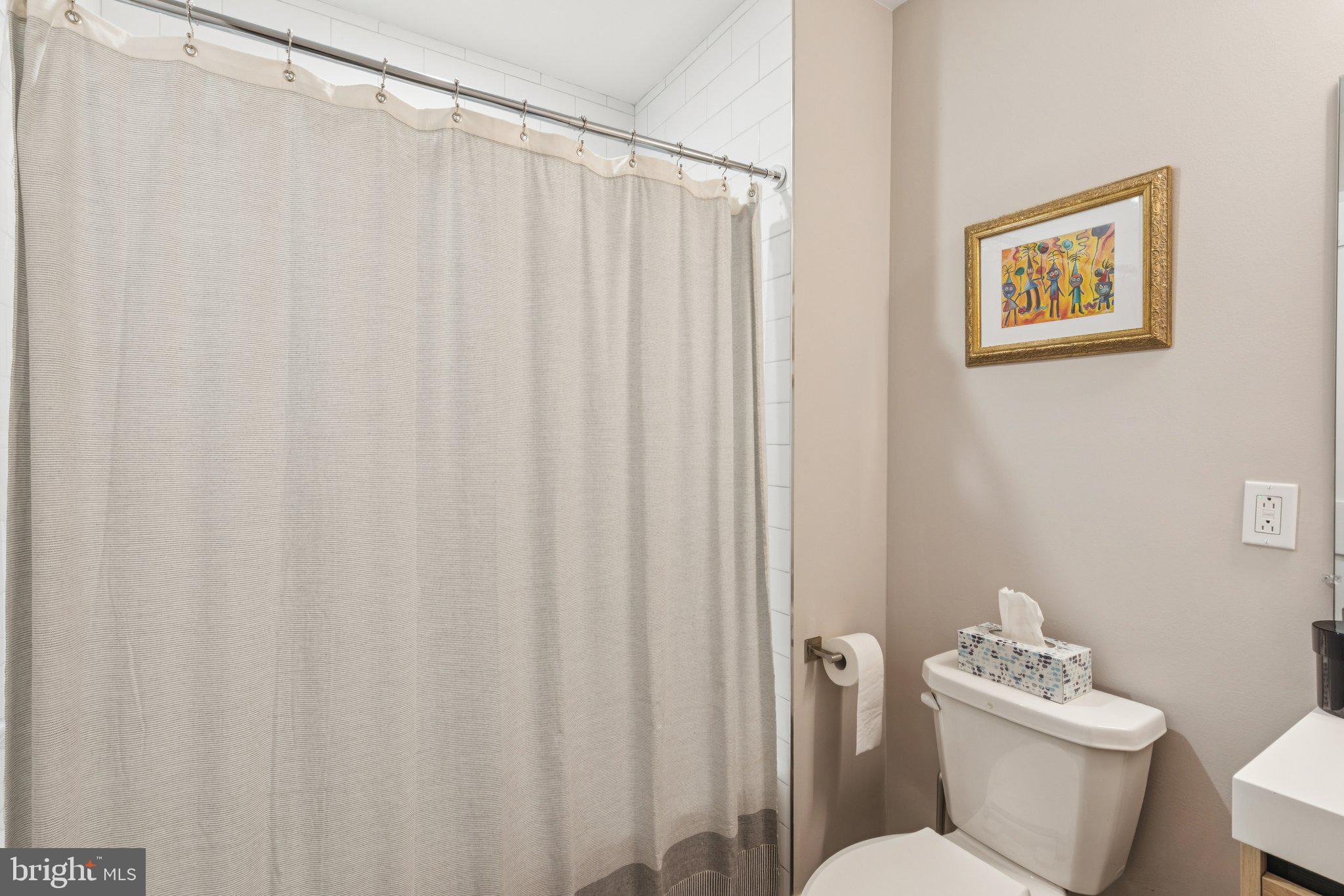 1648-50 Ridge Avenue, Unit 301 Philadelphia, PA 19130 - Photo 22 of 37 a white toilet sitting next to a shower curtain