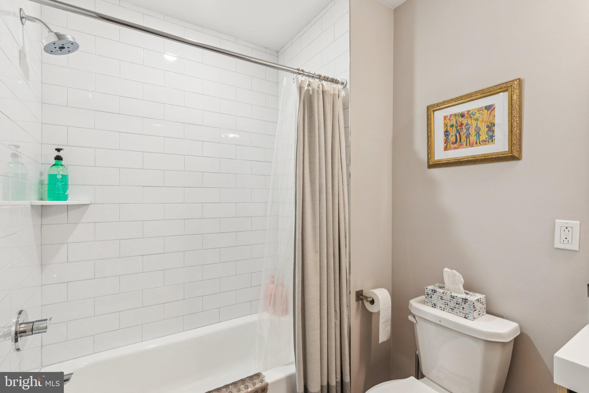 1648-50 Ridge Avenue, Unit 301 Philadelphia, PA 19130 - Photo 23 of 37 a bathroom with a shower and a toilet