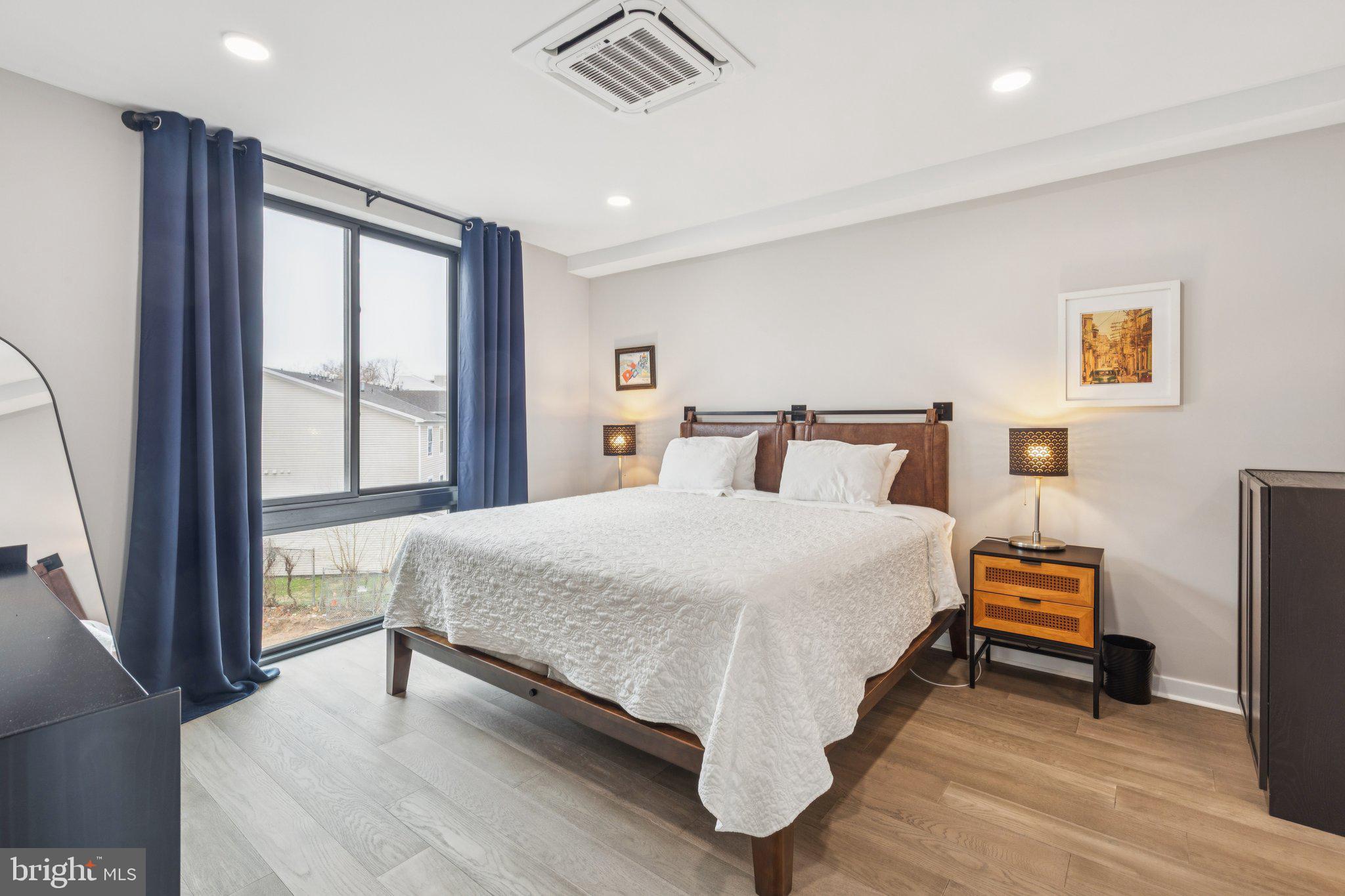 1648-50 Ridge Avenue, Unit 301 Philadelphia, PA 19130 - Photo 25 of 37 a bedroom with a bed and a large window