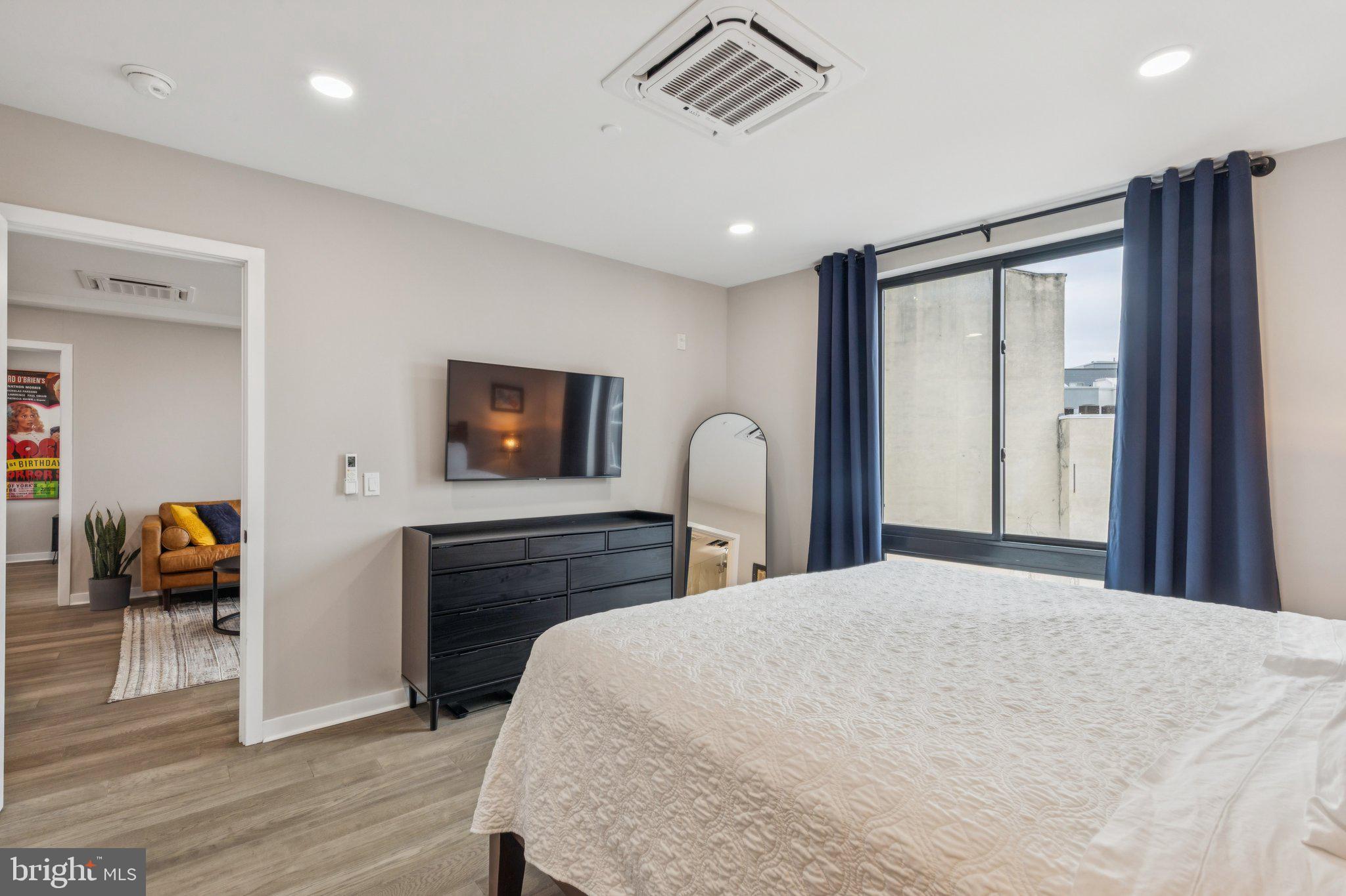 1648-50 Ridge Avenue, Unit 301 Philadelphia, PA 19130 - Photo 27 of 37 a bedroom with a bed and a television