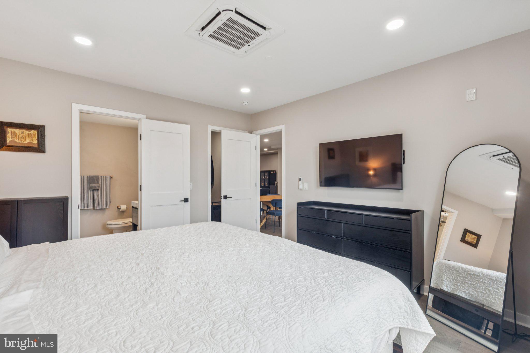 1648-50 Ridge Avenue, Unit 301 Philadelphia, PA 19130 - Photo 28 of 37 a bedroom with a bed and a flat screen tv