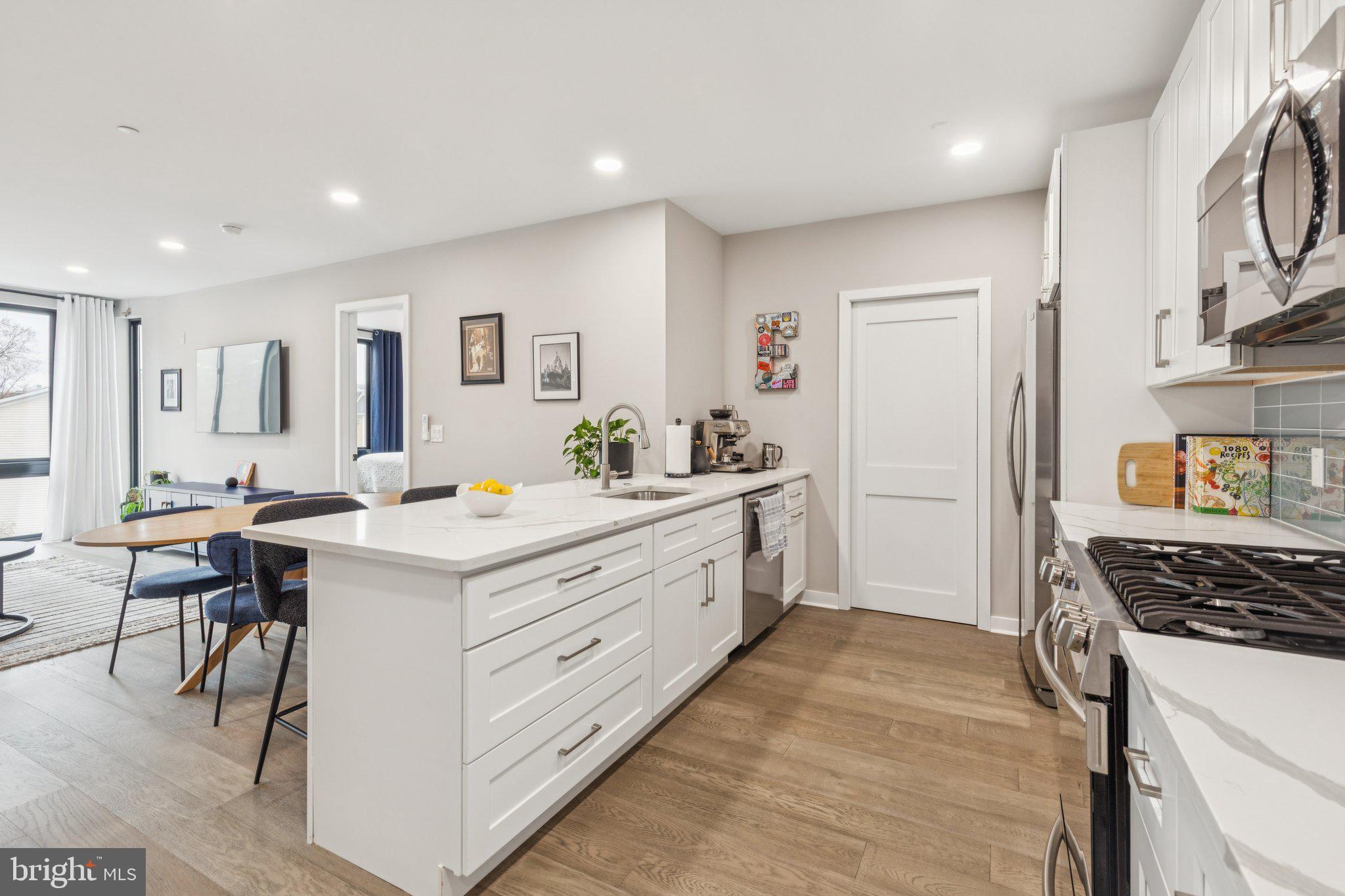 1648-50 Ridge Avenue, Unit 301 Philadelphia, PA 19130 - Photo 6 of 37 a kitchen with a sink stove and cabinets