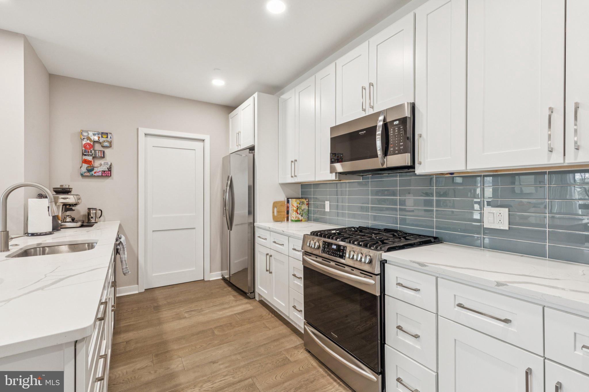 1648-50 Ridge Avenue, Unit 301 Philadelphia, PA 19130 - Photo 8 of 37 a kitchen with cabinets stainless steel appliances and a sink