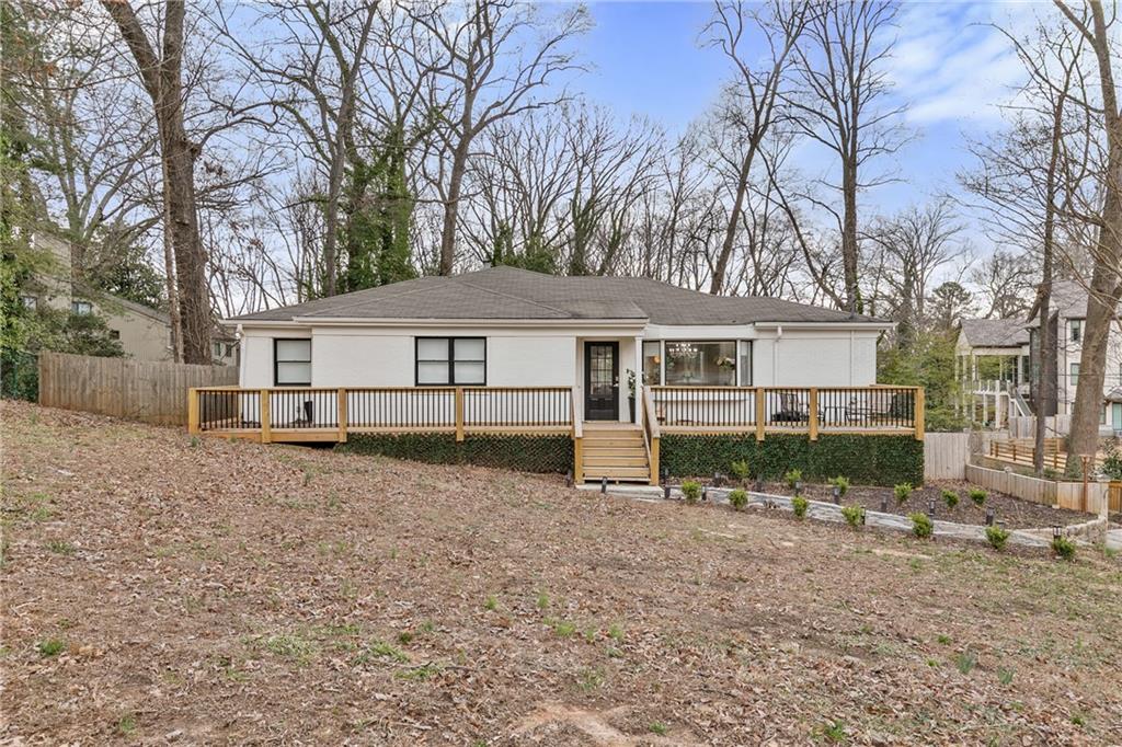 a view of a house with a yard covered in snow