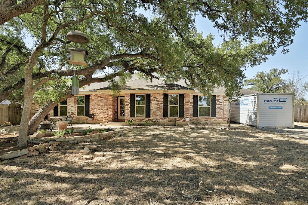 a big house with a tree in front of it