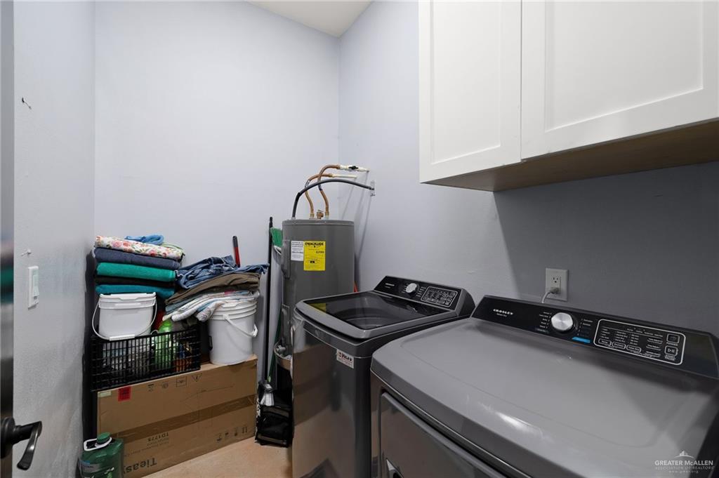 2991 North Us Highway Roma, TX 78584 - Photo 18 of 28 Laundry room with independent washer and dryer, cabinet space, and electric water heater
