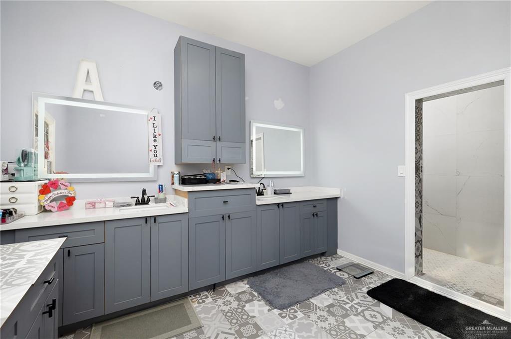 2991 North Us Highway Roma, TX 78584 - Photo 10 of 28 Full bath featuring double vanity, a walk in shower, and light tile patterned flooring