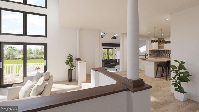 a dining room with furniture and a potted plant