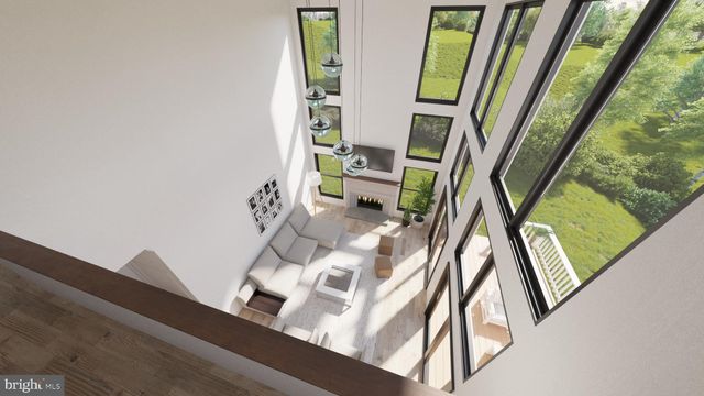 a view of living room with furniture and a mirror