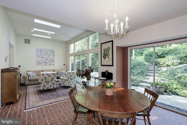 a view of a dining room with furniture a chandelier and wooden floor