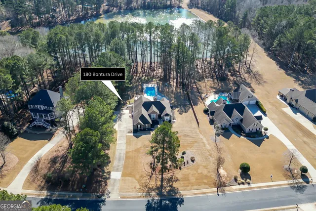 an aerial view of a house with a yard and garden