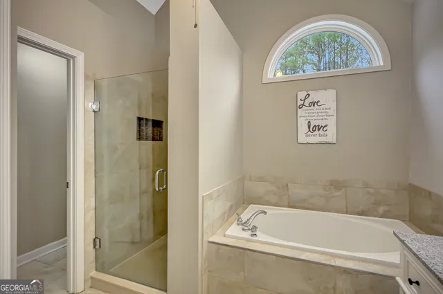 a white bath tub sitting next to a bathroom