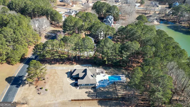 an aerial view of a house with a yard and lake view