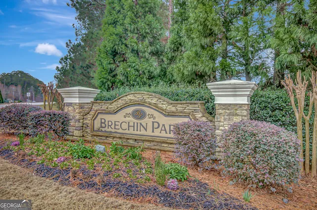 a view of sign board and green space