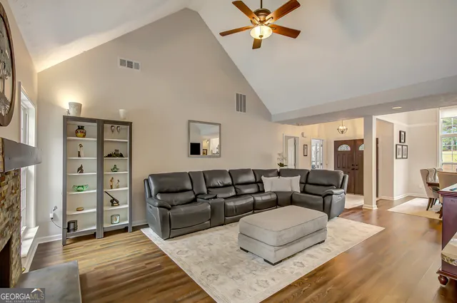 a living room with furniture and wooden floor