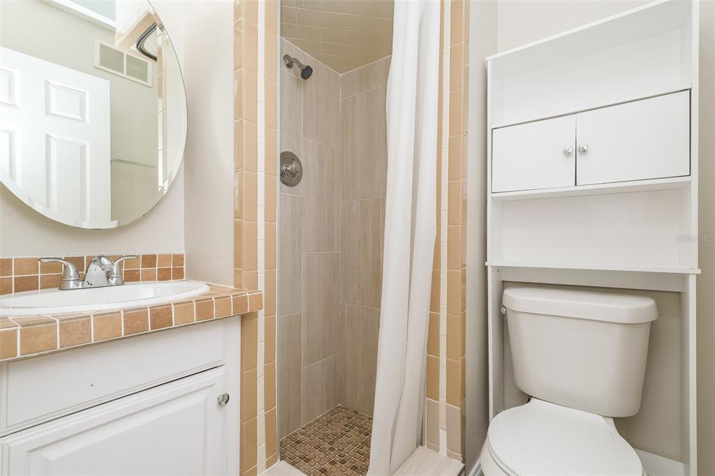 Undisclosed Address Clearwater, FL 33755 - Photo 12 of 15 a bathroom with a toilet sink vanity and shower