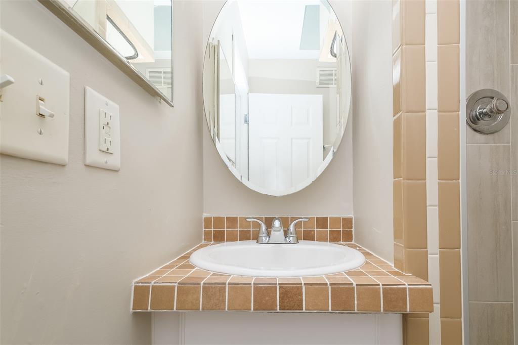 Undisclosed Address Clearwater, FL 33755 - Photo 13 of 15 a bathroom with a sink and a mirror