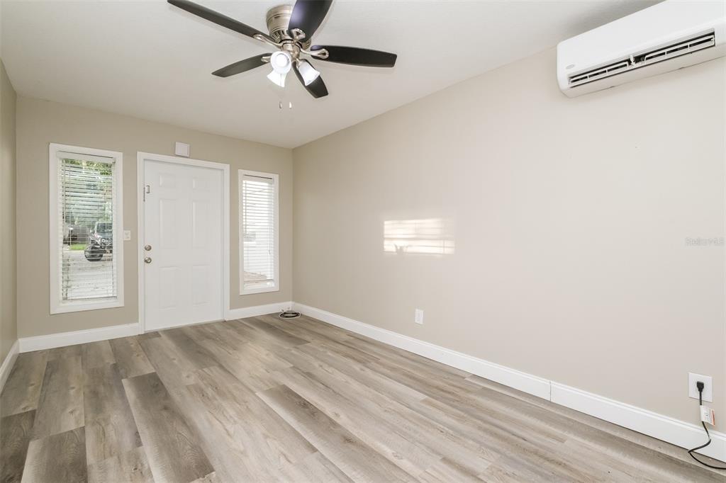 Undisclosed Address Clearwater, FL 33755 - Photo 2 of 15 a view of an empty room with window and chandelier fan