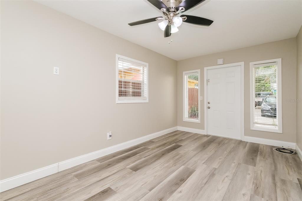 Undisclosed Address Clearwater, FL 33755 - Photo 5 of 15 a view of an empty room with a window and wooden floor