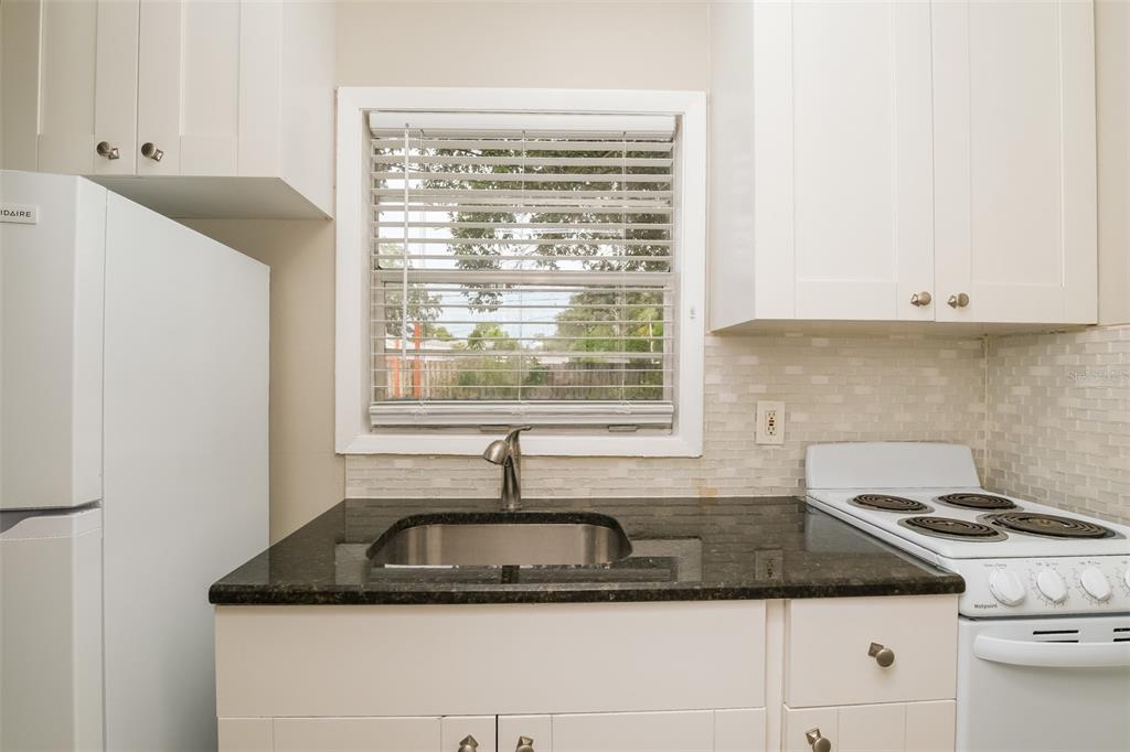 Undisclosed Address Clearwater, FL 33755 - Photo 8 of 15 a kitchen with a sink cabinets and window