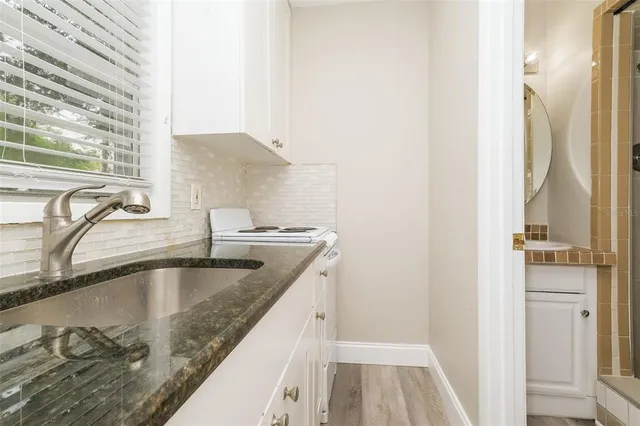 a view bathroom with a granite countertop sink